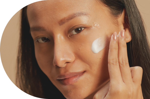 woman applying cream on face