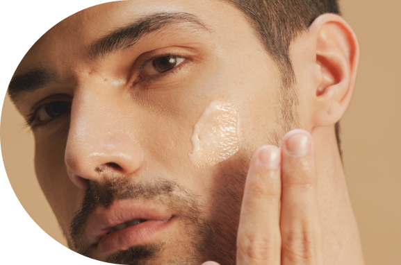 man applying cream on face