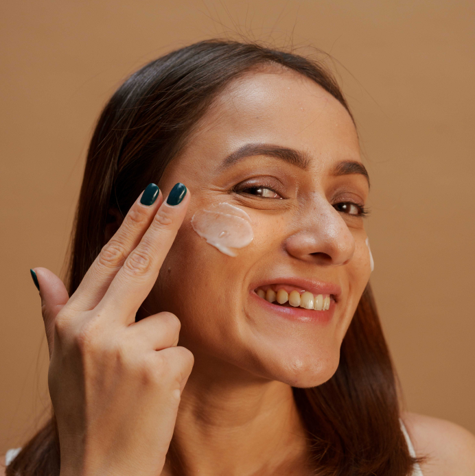 happy woman applying face cream