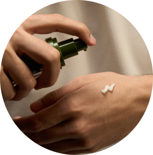 man's hands taking cream from container on hand