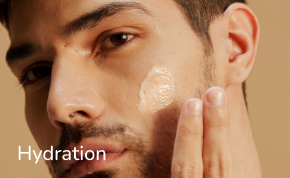 man applying cream on face