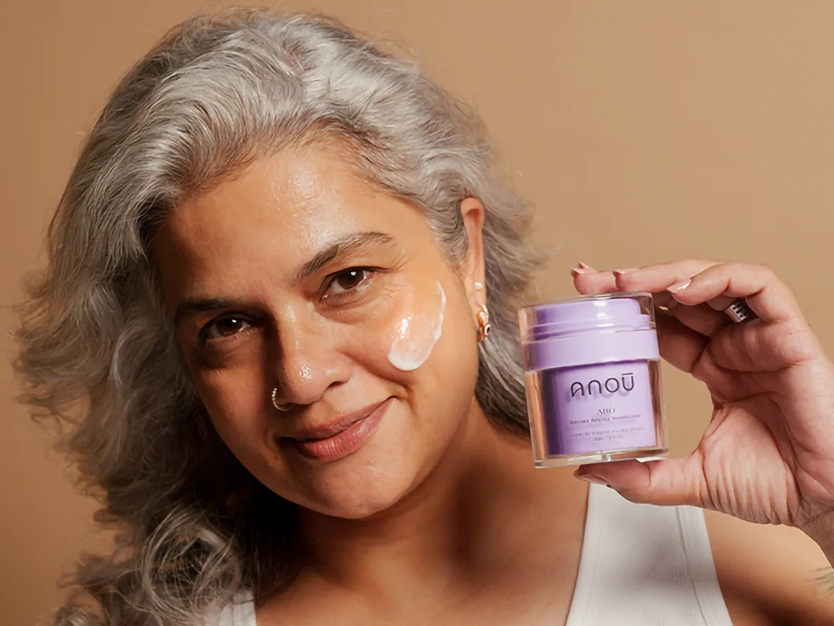 Founder holding Anoū Arō moisturizer