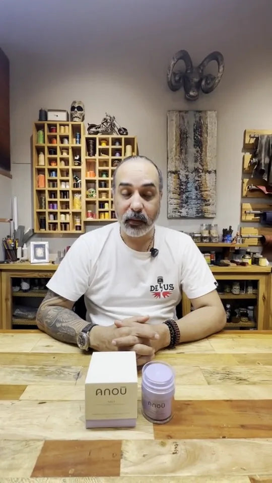 Video still of a man seated at a wooden table with an Arō jar and box.